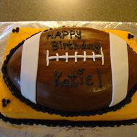 Football Cake Football Cake for 11yr old Birthday. She LOVES the Steelers so we did a black and gold Buttercream with a MMF Football Cake on top.