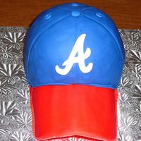 Atlanta Braves Hat Cake use half sports ball and 6" pan. white cake w/ choco bc. gumpast brim and all covered in fondant. "a" was cut from fondant...