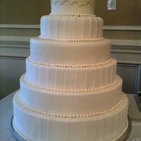 Wedding Show Display Cake This is a display cake I did for my first wedding show. Styrofoam forms, fondant, gumpaste lilies and pearls
