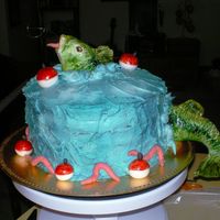 Fishing! Made for my father. 4 layer german chocolate with buttercream and fondant bass fish, fondant lures and worms.