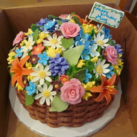 Flowers For Mom Chocolate cake with chocolate icing. Gum paste and fondant flowers with a gum paste tag with writing and detail done with food coloring pen...
