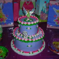 Tinkerbell's Garden 10" and 6" round cakes. Top funfetti and bottom strawberry. All buttercream except for fondant flowers and silver dragees. Oh,...