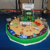 Cars Made this cake for my grandson's 5th birthday. It is 18 in. round yelloe cake with strawberry filling. Buttercream icing. Fondant...