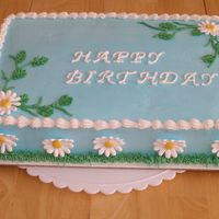 Spring Birthday Royal icing daisies decorate this cake. The bottom border was done with the multiple opening tip to resemble grass.