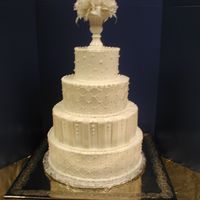 Wedding Pearls Iced in white BC. Painted diamonds are with super pearl. Fondant strips. Cake is 3 layers in each tier.