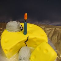 Cheese This is a fondant covered cake. Candle make of fondant. The mice are small egg cakes covered in BC