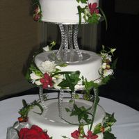 My First Wedding Cake My first wedding cake - 12" is chocolate, 10" is caramel, 8" is vanilla. Flowers are real. Was pleased with the result