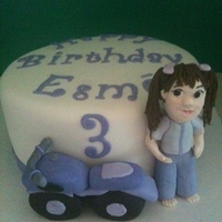 Purple Motorcycle 8" fondant covered cake with sculpted motorcycle and figure.