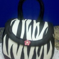 Zebra Purse I made this cake for a coworker. Choc cake with choc fudge filling frosted with BC and covered with MMF. Handle is Gumpaste airbrushed...