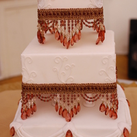 Ivory And Red Beaded The cake is a red velvet with cream cheese filling, the scroll work is fondant , the beads were provided by the bride. Thanks for looking...