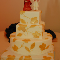 White And Gold the toppers are made from gumpaste, they took forever to make : )thanks for looking