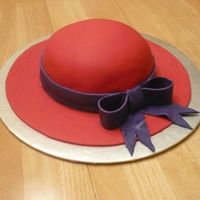 Red Hat Society Cake Chocolate cake with red fondant. Bill of hat is also fondant. Purple ribbon and bow is also fondant.