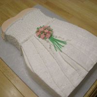 Wedding Dress Cake White chocolate cake with white BC. Used a heart shaped pan and a square pan. Carved the body and then decorated with Cornelli Lace and a...