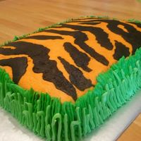 Tiger In Grass Cake Vanilla cake covered in buttercream. The grass is two different shades of green buttercream. The stripes are made from store bought...