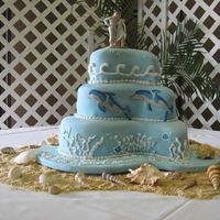 Dolphin Wedding Cake Paisley cake pans. White cake with passion fruit filling covered in fondant. Dolphins are fondant and all other decorations buttercream....