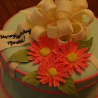 Gerbera Daisy Birthday Request was for a feminine cake with a bow using the colors of pink and blue. This was my take on that. My first time doing the daisies,...