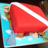 Scuba Diving Flag Simple vanilla cake, rolled fondant, gumpaste decorations and brown sugar sand effect.