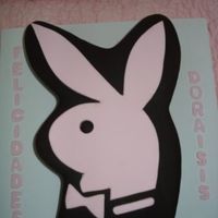 Playboy Logo For A Playgirl Hand carved simple chocolate fudge cake, chocolate buttercream crumb coated and finished in rolled chocolate flavor fondant. Logo in pink...