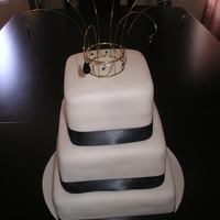 Simple Wedding Cake This was my first wedding cake. It's very simple with a wire and bead topper with ostrich feathers in the middle.