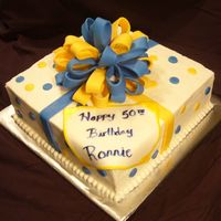 Present Cake 12 in square yellow, bc fill/frost. fondant accents. 1st bow, 1st square pan, 1st plaque/paint technique. need to work on putting my bows...