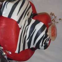 Zebra And Diamond Bachlorette Cake red fondant with zebra drape, the diamond on top is edible, the smaller diamonds are not