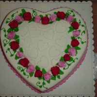 Pink And Red Rosebuds On A Layered Heart Yellow cake filled with cherry pie filling.