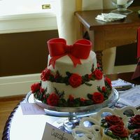Christmas Roses With Bow Buttercream icing and roses/leaves with fondant bow.