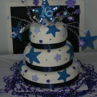 Mackey's Sweet 16 Sweet 16 birthday cake. Rolled fondant icing with satin ribbon. Fun cake to do. Stars on top are wired gum paste with rhinestones applied...