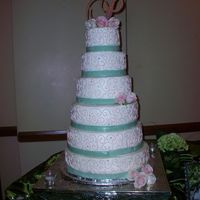 Perez Wedding buttercream cake with fondant ribbon and fresh roses