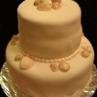 Seashells Yellow cake with Lemon cream cheese filling. Fondant with white chocolate seashells. Thanks for looking. :)