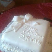 A White Christmas Christmas cake for my sister's job--sylvan learning center. It's a french vanilla almond cake covered in fondant with a ton of...