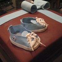 Brown/blue Baby Shower Cake Chocolate cake with coconut buttercream filling. Covered in chocolate fondant. Baby converse made with instructions found here on CC (all...