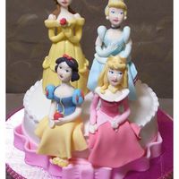 Princess Cake A cake with four gumpaste dolls of Disney's Princess, Belle, Cinderella, Snow White and Aurora.