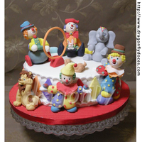 Circus Cake A Circus themed cake with gumpaste clowns and classical circus animal.