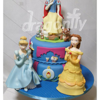 Princess Cake A cake featuring three gumpaste dolls of Disney Princesses, Cinderella, Snow White and Belle (Beauty and the Beast).