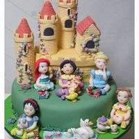 Royal Nursery Cake / Bolo Princesas Baby A cake with a partially edible cake (the central piece is also cake, but the towers' interior is styrofoam) and gumpaste figurines of...