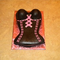 The Corset Chocolate cake carved from a 9x13 frosted in buttercream and covered with MMF. All accents are MMF. Made to match the invitation to a...