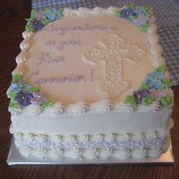 Elizabeth's First Communion 8" square white cake with almond butter cream. Royal icing flowers and lavender cornelli lace "ribbon" along the bottom.