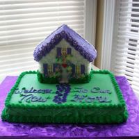 Housewarming Cake Wilton house cake pan on top of a sheet cake pan. Buttercream frosting, fondant sidewal, gumpaste flowers.