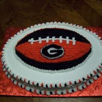 Uga Football Wilton football pan on top of the large oval pan.