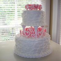 Heartcake_Small.jpg Buttercream frosting. I made the hearts out of fondant and attached them with toothpicks. I piped a buttercream frosting border on the...