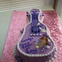 Hannah Montana Wilton guitar pan. Gumpaste daisies. I borrowed the idea from a poster at the Wilton site.