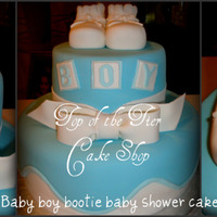 Baby Boy Bootie Baby Shower Cake 2 tiered cake. I believe it was a 6 inch and a 10 inch cake. Vanilla w/ dulce de leche filling covered in fondant. Booties and bow are made...