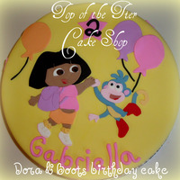Dora & Boots Birthday Cake 11 inch vanilla cake w/ dulce de leche filling covered in fondant. I made a template of Dora & Boots and them out with fondant. TFL!