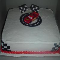 Cars Cake A simple CARS cake... The flags are fondant.. and the car is a toy.. Iced in Bc.. thanks for looking