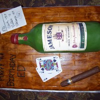 Jameson Bottle Cake This was so much fun to make. The bottom in a sheet cake, covered in fondant and painted with a mix of coloring & vodka for the wood...
