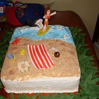 Beach Cake fondant girl surfer and shark on beach with fondant details.