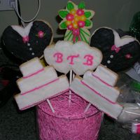 Wedding Cookie Bouquet I used hearts to make the Tux's and freehanded the cake with a pearing knife, I also used the shooting star from the wilton set to...