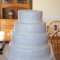 Round, Bc With Dots Second wedding cake. A year after the first LOL. This was taken right before delivery they added roses to it after we dropped it off.