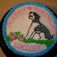 Miniature Schnauzer All buttercream frosting except for silver candy balls on the flowers. The dog is a FBCT.